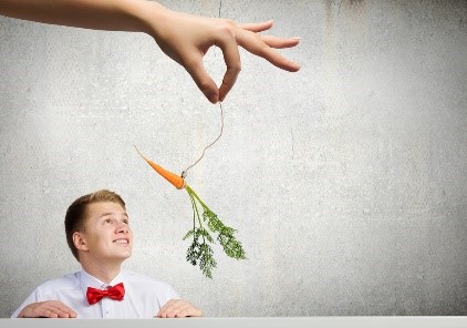 Dangling a carrot in front of a young man